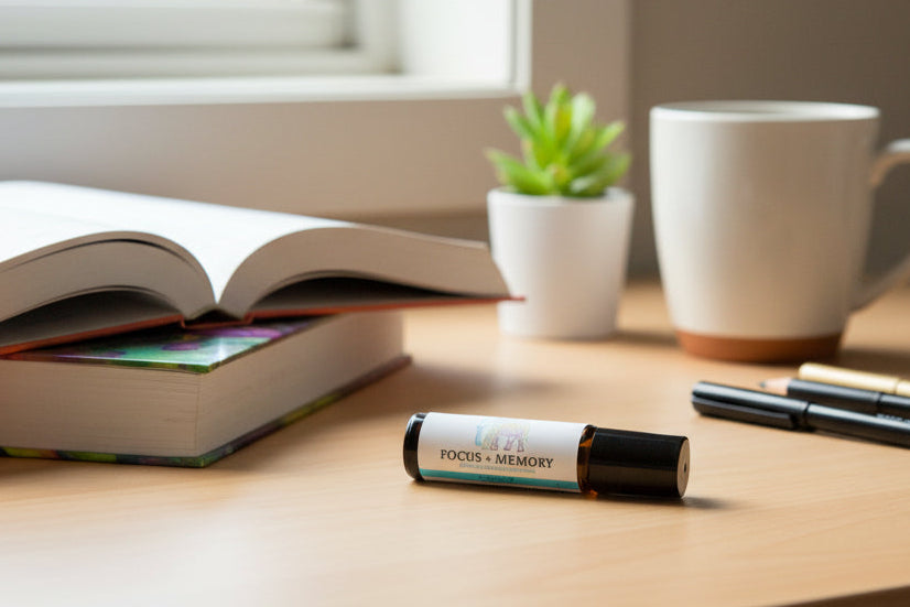 A small cylindrical bottle labeled 'FOCUS + MEMORY' with a white label and black cap, placed on a desk next to open books 