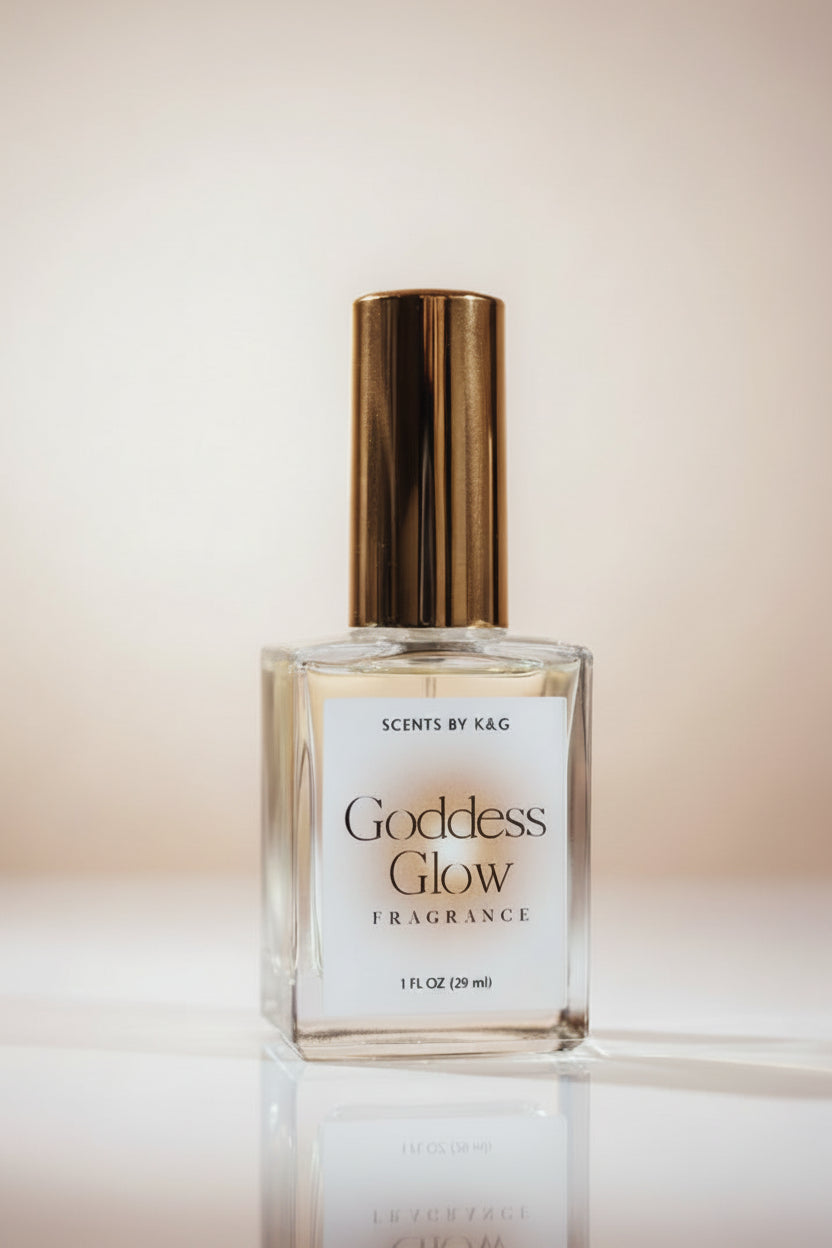 A bottle of Goddess Glow Fragrance by Scents by K&G, featuring a clear glass bottle with a metallic gold cap and a white label, set against a warm beige gradient background